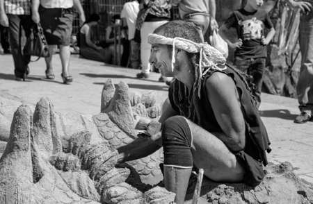 BADAJOZ, SPAIN - SEPTEMBER 25: Costumed sand man sculptor working at the Almossasa Culture Festival...