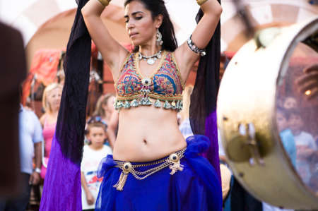 BADAJOZ, SPAIN - SEPTEMBER 25: Belly dancer and arabic music street band at the Almossasa Culture Festival on September 25, 2013 in Badajoz, Spainのeditorial素材