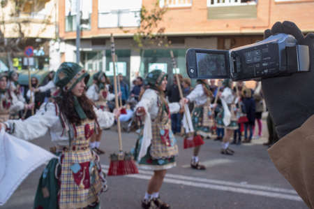Badajoz, Spain - Feb 13, 2018: Man recording San Roque comparsas parade. Badajoz Carnival was recently declared Festivity of International Tourist Interestのeditorial素材