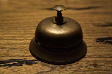 Old service bell on a rural hotel reception deskの写真素材