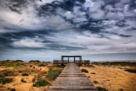Wooden footbridge structures at Cadiz rivermouth beaches, Spain