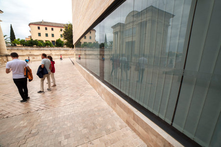 Cordoba, Spain - 2018 Dec 9th: Tourist family outside visitors center of Cordoba, close to Roman arch bridge gate, Cordoba, Spainのeditorial素材