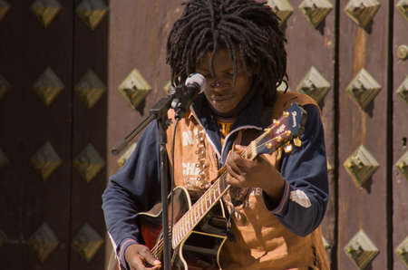 GRANADA, SPAIN, MARCH 7: Black rasta street musician man playing at Granada downtown, Spain on 7 March 2009のeditorial素材