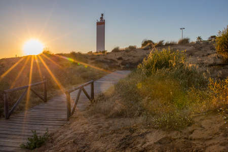 Costa de la Luz promenade all along the lighthouse at sunset, Almonte, Huelva, Spainの写真素材