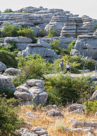 Antequera, Spain - July 14, 2017: visitors walking by Torcal Natural Park trail, Malaga, Spain