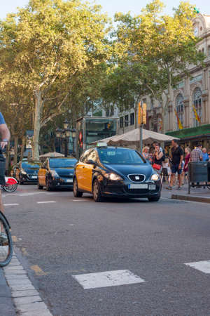 Barcelona, Spain - July 23, 2016: Taxi car goes by Ramblas avenue in Barcelona Cityのeditorial素材