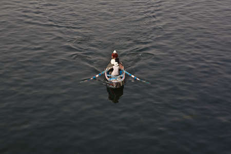 ASWAN, EGYPT - JULY 17: Unidentified men paddle their boat on the Nile river on July 17, 2010 in Aswan, Egypt. Nile river is generally regarded as the longest river in the worldのeditorial素材