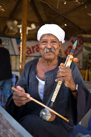 LUXOR, EGYPT - JULY 19: A musician perform outside tourist attractions on July 19, 2010 in Luxor, Egypt. Local entertainers frequently perform at local tourist attractionsのeditorial素材