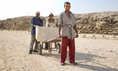 SAQQARA, EGYPT - JUL 21: Unidentified men work for restoration of Saqqara Pyramid area, on July 21, 2010, Saqqara, Egyptのeditorial素材