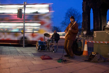 EDINBURGH, SCOTLAND, - MARCH 4: Street Musicians in Downtown during a cold sunset, close to Scott...