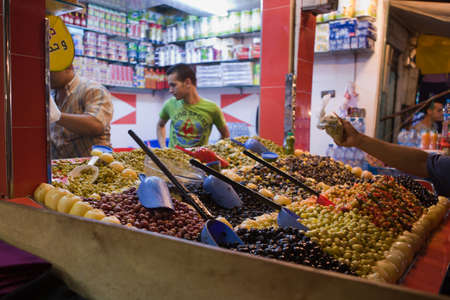 TETOUAN, MOROCCO - AUGUST 17: Unknown man trades a green olives in a Market on August 17, 2014 in Tetouan, Moroccoのeditorial素材