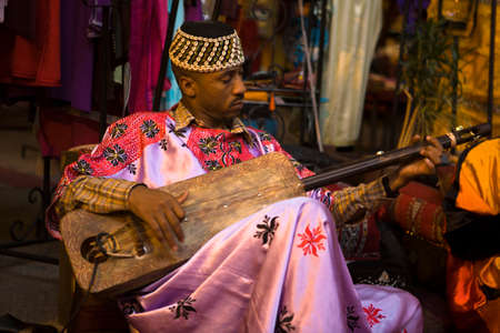 MARRAKESH, MOROCCO - OCTOBER 22: Unidentified Moroccan Gnawa musician playing gimbri in Marrakech, Morocco on October 22th, 2011, Marrakesh, Moroccoのeditorial素材