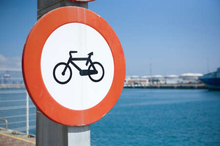 Bike lane symbol on blue background beside the seaportの写真素材