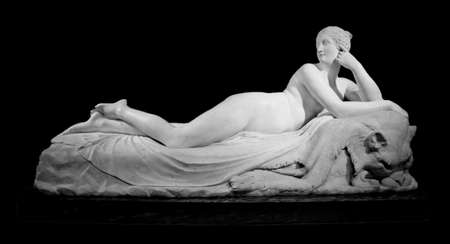 Naked woman marble lied statue with lion skin, isolated on black backgroundのeditorial素材