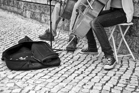 Street girl musician playing on violoncello, Lisbon, Portugalの写真素材
