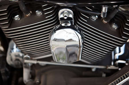 Close up of an engine of a silver shining motorbike