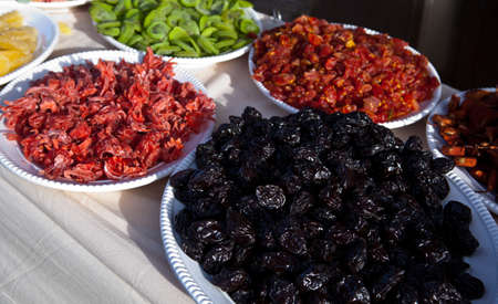 Assorted dried fruits in big white plates, ready for sellの写真素材