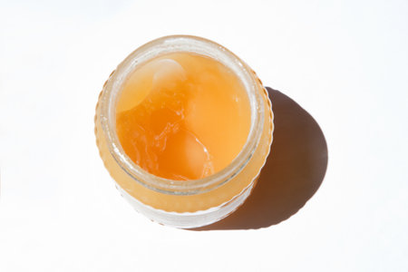 Glass jars with honey from La Alcarria, Guadalajara, Spain. Isolated over white backgroundの写真素材