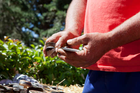 hardened working hands holding sheep shearing scissorsの写真素材