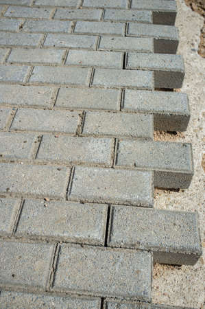 Concrete cobblestones pavement under construction. Laying Interlocking paving pieces