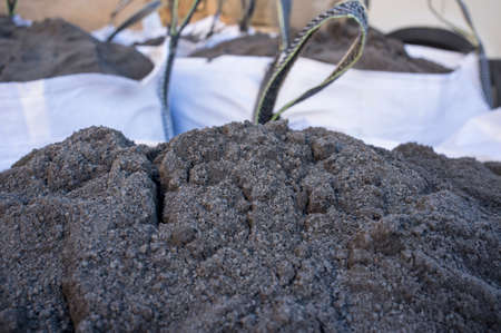 Raffia large sack of black topsoil. Selective focus