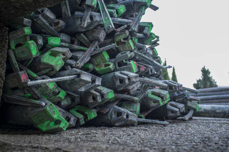 Scaffolds elements piled at old town construction site. Spray paint marked on them
