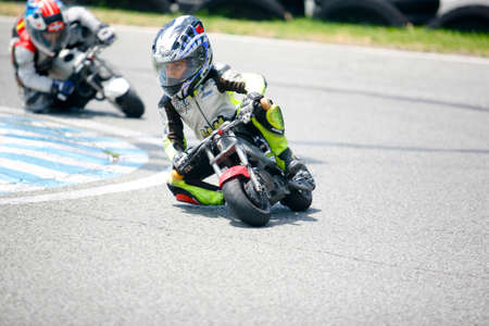 MARBELLA - JUL 5: kids riding freestyle Motocross bikes on asphalt. Junior competition training at Funny Beach circuit on July 5, 2015 in Marbella, Spainのeditorial素材