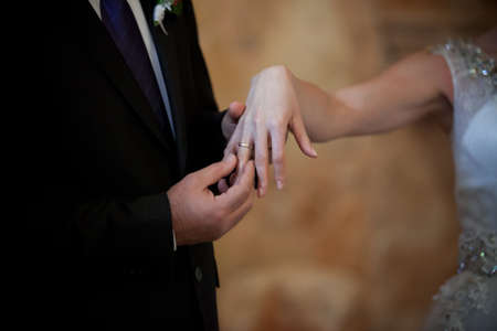 Bride and grooms hands with wedding ringsの写真素材