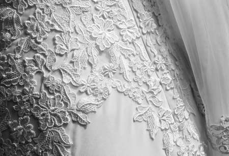 Detail of wedding dress with veil. Texture of the wedding dress with embroidered flowers. black and white picturesの写真素材