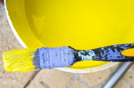 Used flat decorator brush covered with dry blue chalk and wet yellow color. closeupの写真素材