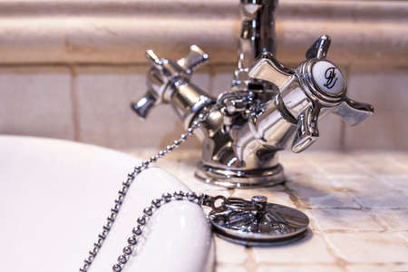 Retro style chrome basin faucet. Plug with chain