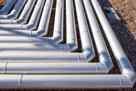 Pipes for heating and air conditioning recuperator at building roof. Corner elbow joints