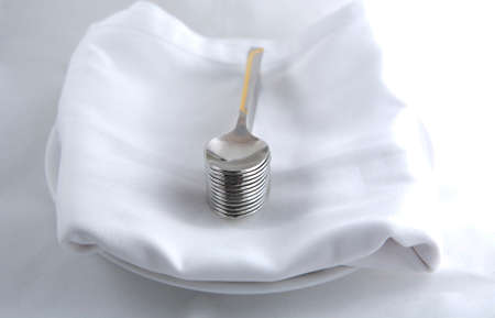 Dessert spoons over a white napkin in a plate