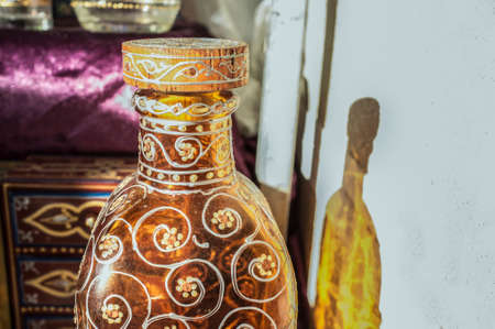 Decorated glass bottle with floral motifs. closeupの写真素材