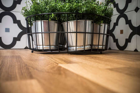 Artificial zinc plant pots over wooden counter in kitchen. selective focusの写真素材