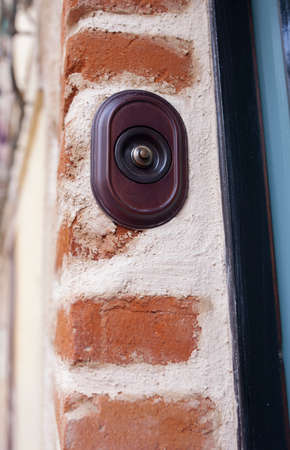 Rustic style doorbell button made of wood and brass. Selective focusの写真素材