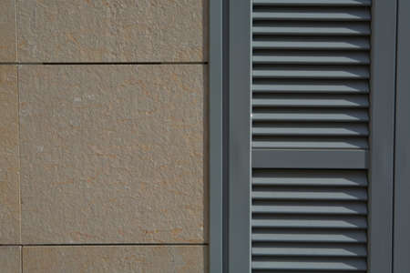 Metallic blue shutter over stone tiles wall backgroundの写真素材