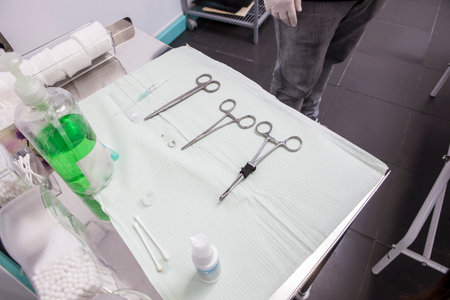 Piercing professional table with several tools as grips, forceps, needles, jewels, cannula, catheter, etc.の写真素材