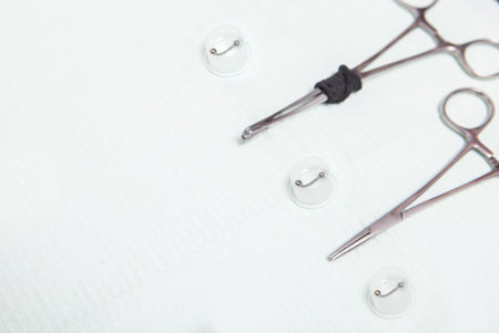 Piercing professional table with grips, forceps and jewels. overhead shotの写真素材