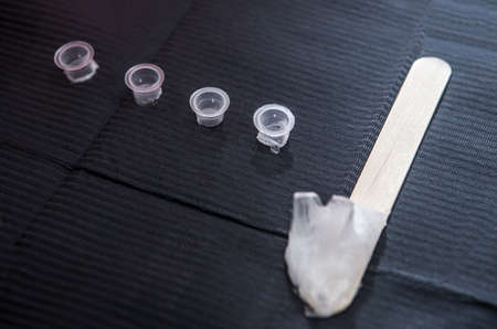 Small caps for ink and depressor full of vaseline. First stage of tattoo process