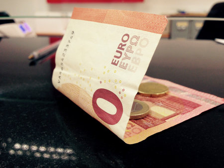 Money on surface near cash department window. closeup
