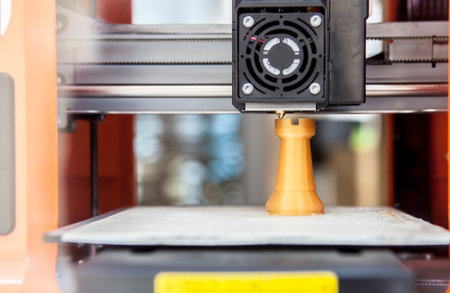 3d printer making plastic chess piece. Printing machine working three dimensional item