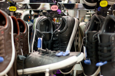 Lots of black and brown leather sneakers on sale, mall, shopping mall, shopping centerの写真素材
