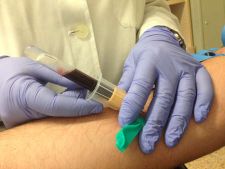 Nurse taking a blood sample from patient. closeup