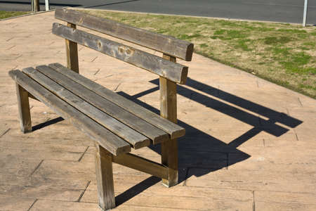 Rustic wooden bench in the park, Huelva, Spain