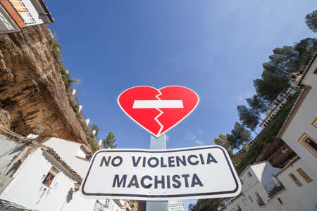 Setenil, Spain - March 4th, 2019: Gender violence campaign with traffic signals in Spanish town. Broken heart shaped traffic signal. Setenil de las Bodegas, Cadiz, Spainのeditorial素材
