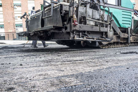 Work on the laying of asphalt in the city. Paving applicator machine or paver at workの写真素材