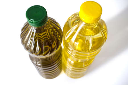 Olive versus sunflower oil bottled in PET. Upper area. isolated over white