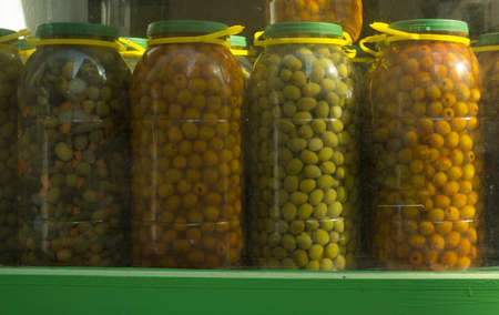 Huge plastic jugs of spanish pickles olives. Some varieties used in hospitalityの写真素材