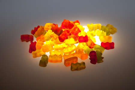 Pile of colorful gummy bears isolated over white background